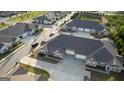 Aerial view showcases modern townhomes with attached garages, ample parking, and landscaped surroundings at 2929 Rambler Dr, Loganville, GA 30052