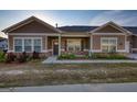 Charming townhouse exterior with brick accents, a cozy front porch, and manicured landscaping at 2929 Rambler Dr, Loganville, GA 30052