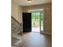 Bright foyer with hardwood floors, staircase, and front door with sidelights at 1555 South Bethany Rd, Locust Grove, GA 30248