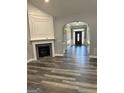 Spacious living room featuring a fireplace, hardwood floors, and arched entryway to the foyer at 2200 Hickory Station Cir, Snellville, GA 30078