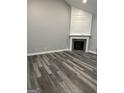 View of a cozy living room with hardwood floors, fireplace and neutral wall paint at 2200 Hickory Station Cir, Snellville, GA 30078