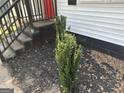 Close-up of the front porch featuring stairs and small, decorative bushes at 1681 Stanton Sw Rd, Atlanta, GA 30311