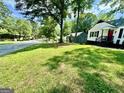 View of front yard showcasing a spacious lawn with a home in the background at 1681 Stanton Sw Rd, Atlanta, GA 30311