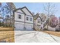 Beautiful two-story home showcasing a spacious driveway, a two-car garage, and a picturesque natural setting at 3278 Greenhill Dr, Villa Rica, GA 30180