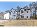 Stylish two-story home with stone accents, a two-car garage, and a well-manicured lawn at 3278 Greenhill Dr, Villa Rica, GA 30180