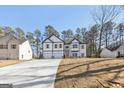 Lovely two-story house with a two-car garage, a long driveway, and attractive architectural details at 3278 Greenhill Dr, Villa Rica, GA 30180