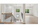 Bright foyer with hardwood floors, a staircase, and large windows providing natural light at 2279 Lakeview Pkwy, Villa Rica, GA 30180