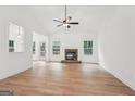 Spacious living room with vaulted ceiling, a stone fireplace, and large windows overlooking the backyard at 2279 Lakeview Pkwy, Villa Rica, GA 30180