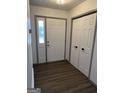 Bright entryway featuring modern flooring, a paneled front door, and a closet with bi-fold doors at 5526 Stoneleigh Court, Stone Mountain, GA 30088