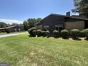 Well-maintained yard with healthy green grass and manicured shrubbery surrounding the building at 5526 Stoneleigh Court, Stone Mountain, GA 30088