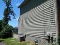 Side view of home showing vinyl siding, utilities and a partial view of the backyard at 3683 Brown Dr, Decatur, GA 30034