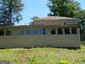 Exterior of home featuring a large sunroom addition, with multiple windows at 3683 Brown Dr, Decatur, GA 30034