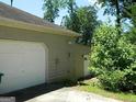 Attached two-car garage with a white door and adjacent entrance at 3683 Brown Dr, Decatur, GA 30034