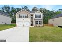 Traditional two-story home showcasing a manicured lawn, two-car garage, and brick and siding accents at 768 Great Oak Place # 26, Villa Rica, GA 30180