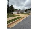 Charming single-story home featuring a well-maintained lawn and a convenient two-car garage at 170 Forray Dr, Covington, GA 30016