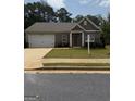 Charming single-story home featuring a brick facade, attached garage, and well-maintained front lawn at 170 Forray Dr, Covington, GA 30016
