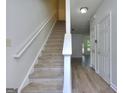 Bright entryway with a staircase and hardwood floors, offering a welcoming space at 5640 Terremont Cir, Norcross, GA 30093