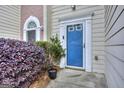 Charming blue front door with glass and white trim, complemented by lush landscaping at 5640 Terremont Cir, Norcross, GA 30093