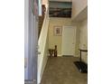 Bright foyer featuring a staircase, neutral decor, and tile flooring at 11657 Flemming Ct, Hampton, GA 30228