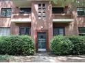 Charming brick apartment building with green door and meticulously maintained landscaping at 1381 Ne Normandy Ne Dr # 4, Atlanta, GA 30306