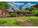 Quaint single-story brick and siding home featuring a cozy front porch at 78 N Pomona Rd, Hampton, GA 30228