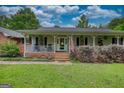 Charming single-story home featuring a welcoming front porch with an American flag at 78 N Pomona Rd, Hampton, GA 30228