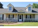 Inviting covered front porch with white railings and rocking chairs, creating a cozy curb appeal at 239 Ferguson Ave, Locust Grove, GA 30248