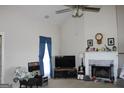 Spacious living room featuring a fireplace and large windows for natural light at 239 Ferguson Ave, Locust Grove, GA 30248