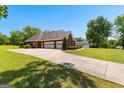 Spacious three-car garage with ample parking and a long driveway on a well-maintained lot at 125 Lake Park Dr, Sharpsburg, GA 30277