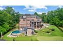 Expansive backyard with a putting green, covered patio, and luxurious in-ground pool at 4320 Blue Ridge Dr, Douglasville, GA 30135