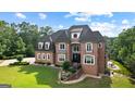 Two-story brick home features classic architecture, a manicured lawn, and mature trees at 4320 Blue Ridge Dr, Douglasville, GA 30135