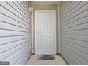 A close up of the white front door on the gray home at 10690 Tara Village Way, Joneboro, GA 30238