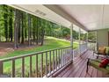 Relaxing covered porch with views of the expansive front yard and wooded surroundings at 145 Adams Ct, Fayetteville, GA 30214
