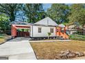 Charming craftsman home with attached carport and inviting front porch with wooden steps at 317 Mcpherson Se Pl, Atlanta, GA 30316
