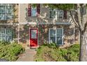 Charming exterior featuring a stone facade, a bright red door, and well-maintained landscaping at 11439 South Grove Dr, Hampton, GA 30228