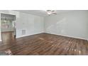 Spacious living room boasts beautiful hardwood floors, ceiling fan, and ample natural light at 11439 South Grove Dr, Hampton, GA 30228