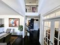 Bright foyer features soaring ceilings and dark hardwood floors with open staircase at 1690 Geranium Ln, Cumming, GA 30040