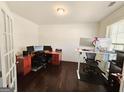 Well-lit home office features wood floors, crown moulding, and multiple work spaces at 1690 Geranium Ln, Cumming, GA 30040