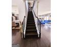 View of a staircase with modern iron spindles leading to the second floor at 1690 Geranium Ln, Cumming, GA 30040