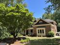 A glimpse of a well-maintained brick home with a charming porch and lovely landscaping at 245 River Laurel Way, Woodstock, GA 30188