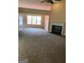 Inviting living room features a fireplace and large windows allowing natural light at 436 Abbey Pl, Villa Rica, GA 30180