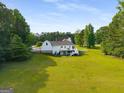 Expansive backyard featuring a large, well-maintained lawn and a two-story home at 692 Brooks Woolsey Rd, Brooks, GA 30205