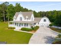Beautiful two-story home with an attached garage and spacious driveway at 692 Brooks Woolsey Rd, Brooks, GA 30205