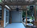 Cozy patio area with a decorative pergola, ideal for outdoor dining and entertaining with string lights at 123 Chippewa Run, Auburn, GA 30011