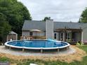 Backyard features a refreshing above-ground pool, perfect for summer relaxation and outdoor entertaining at 123 Chippewa Run, Auburn, GA 30011