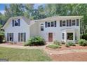 Beautifully landscaped two-story home with a well-manicured lawn and a red front door at 157 Rockspray Rdg, Peachtree City, GA 30269
