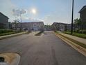 View of the gated townhome community featuring professionally maintained landscaping and sidewalks at 190 Hampton Cir, Mcdonough, GA 30253