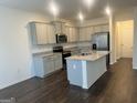 Open kitchen with granite countertops, island, stainless appliances and hardwood floors at 190 Hampton Cir, Mcdonough, GA 30253