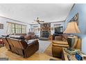 Comfortable living room features a stone fireplace, hardwood floors, and ample seating at 349 Campground Rd, Mcdonough, GA 30253