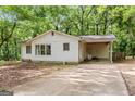 View of the exterior of the home showing the carport and surrounding landscaping at 397 Campground Rd, Mcdonough, GA 30253